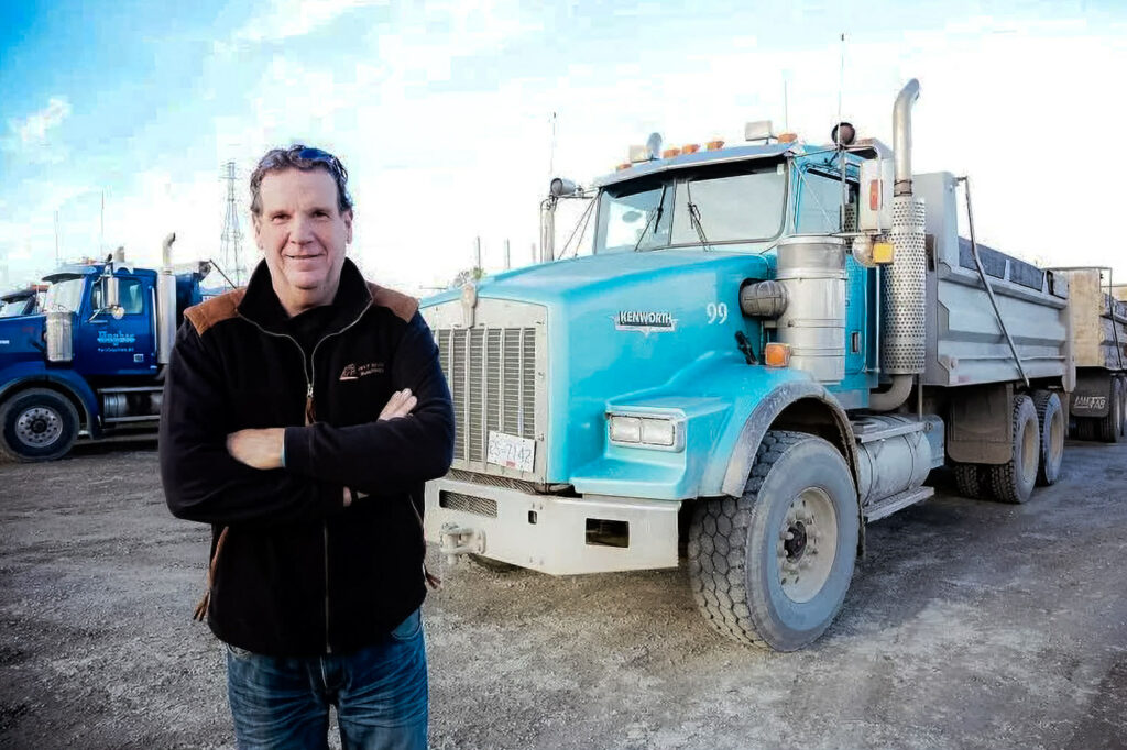 Hughes Trucking equipment and hauling services on site.